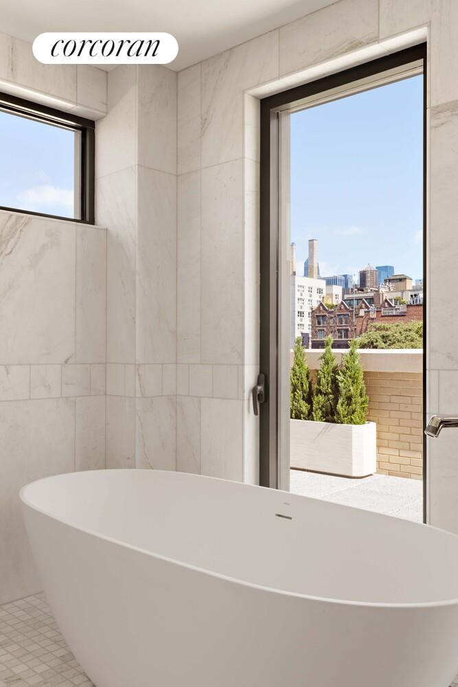 181 MacDougal Street, Unit PH Manhattan, NY 10011 - Photo 15 of 26 a bathroom with a bathtub and window