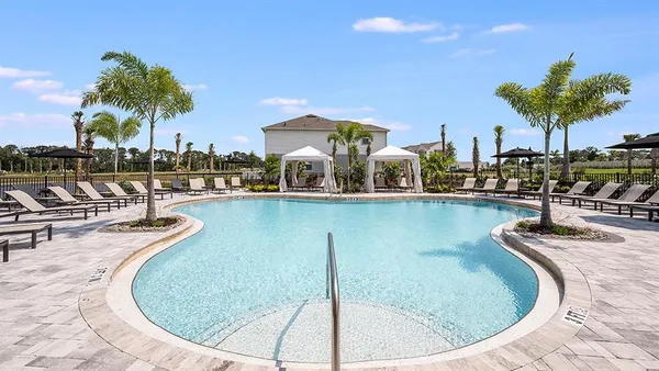 a view of a swimming pool with outdoor seating