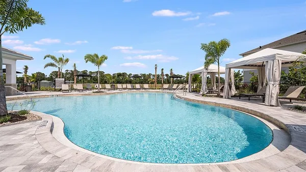 a view of a porch with a table and chairs