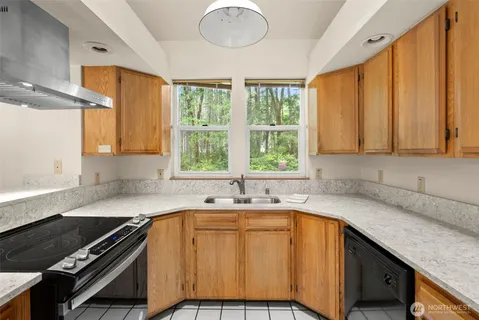 a kitchen with a sink stove and cabinets