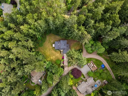 an aerial view of a house with a yard