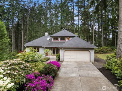 a front view of a house with a yard and fountain