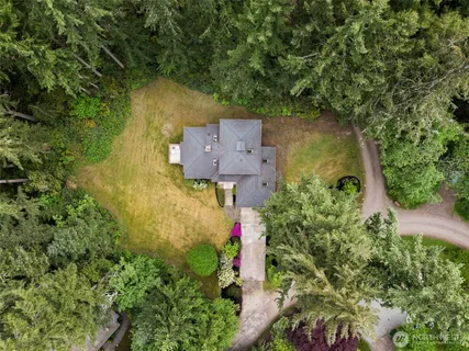 an aerial view of a house with a yard