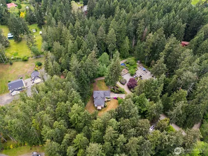 an aerial view of a house with a yard
