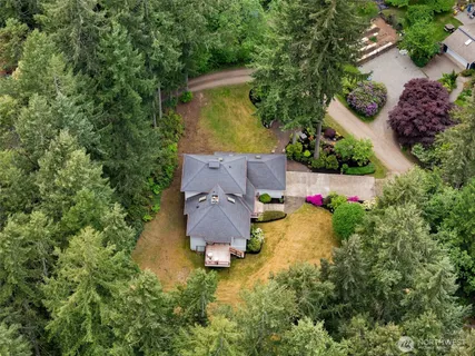 an aerial view of a house with swimming pool and garden