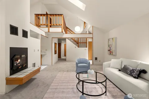 a living room with furniture a fireplace and white walls