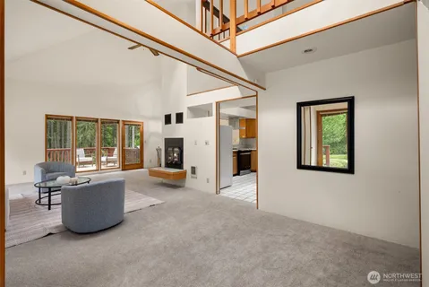 a view of a livingroom with furniture and a window