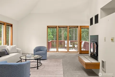 a living room with furniture and a floor to ceiling window