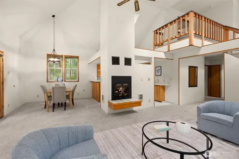 a living room with furniture a fireplace and a chandelier