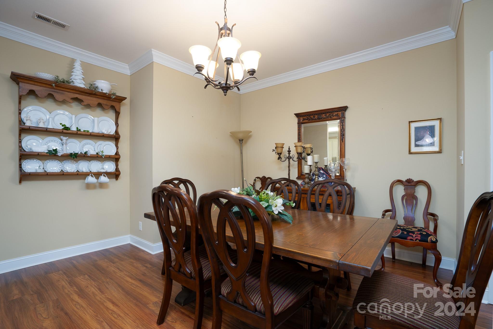 483 Pepperstone Drive Salisbury, NC 28146 - Photo 16 of 35 a view of a dining room with furniture wooden floor and chandelier