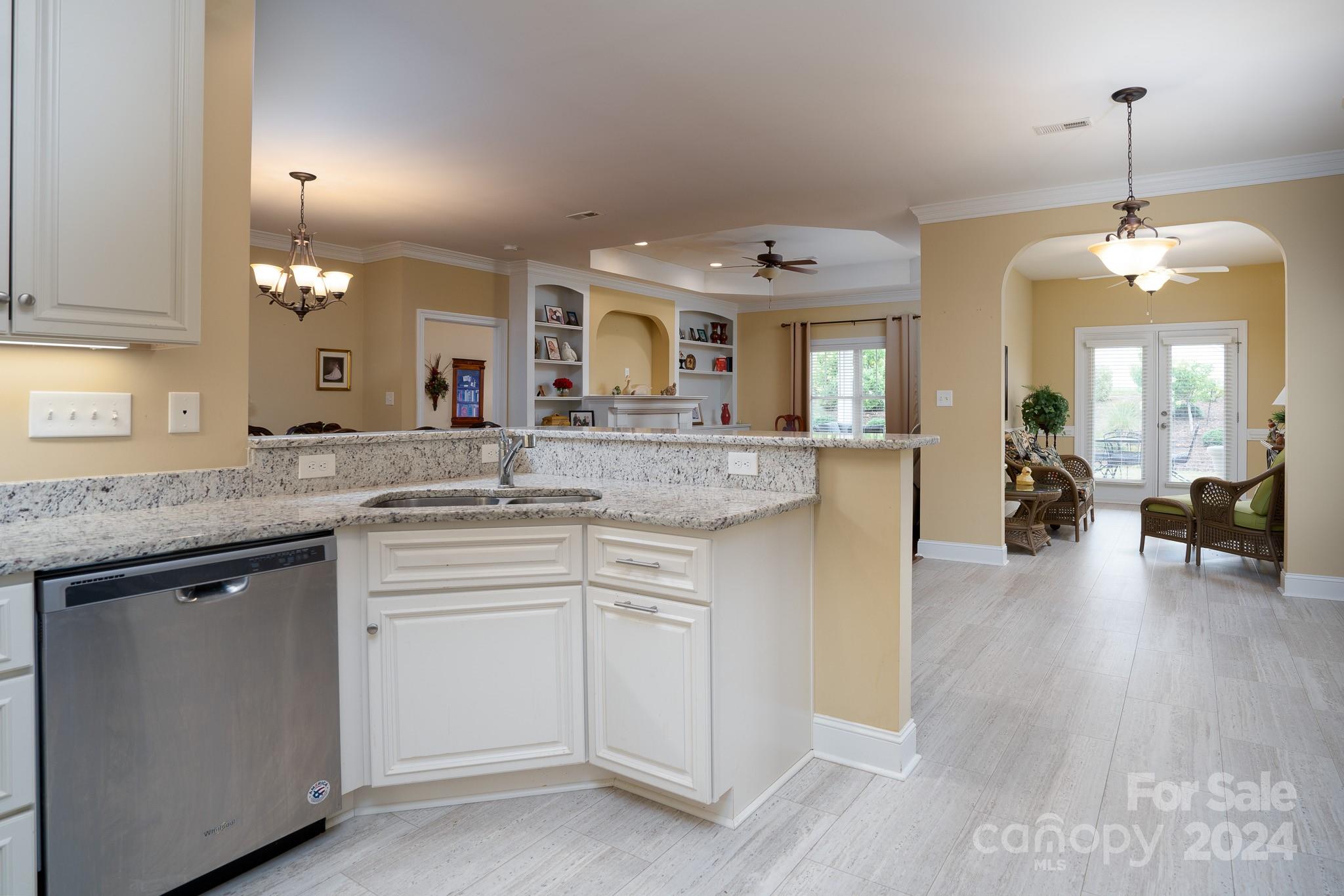 483 Pepperstone Drive Salisbury, NC 28146 - Photo 22 of 35 a open kitchen with a sink dishwasher a dining table and chairs with wooden floor