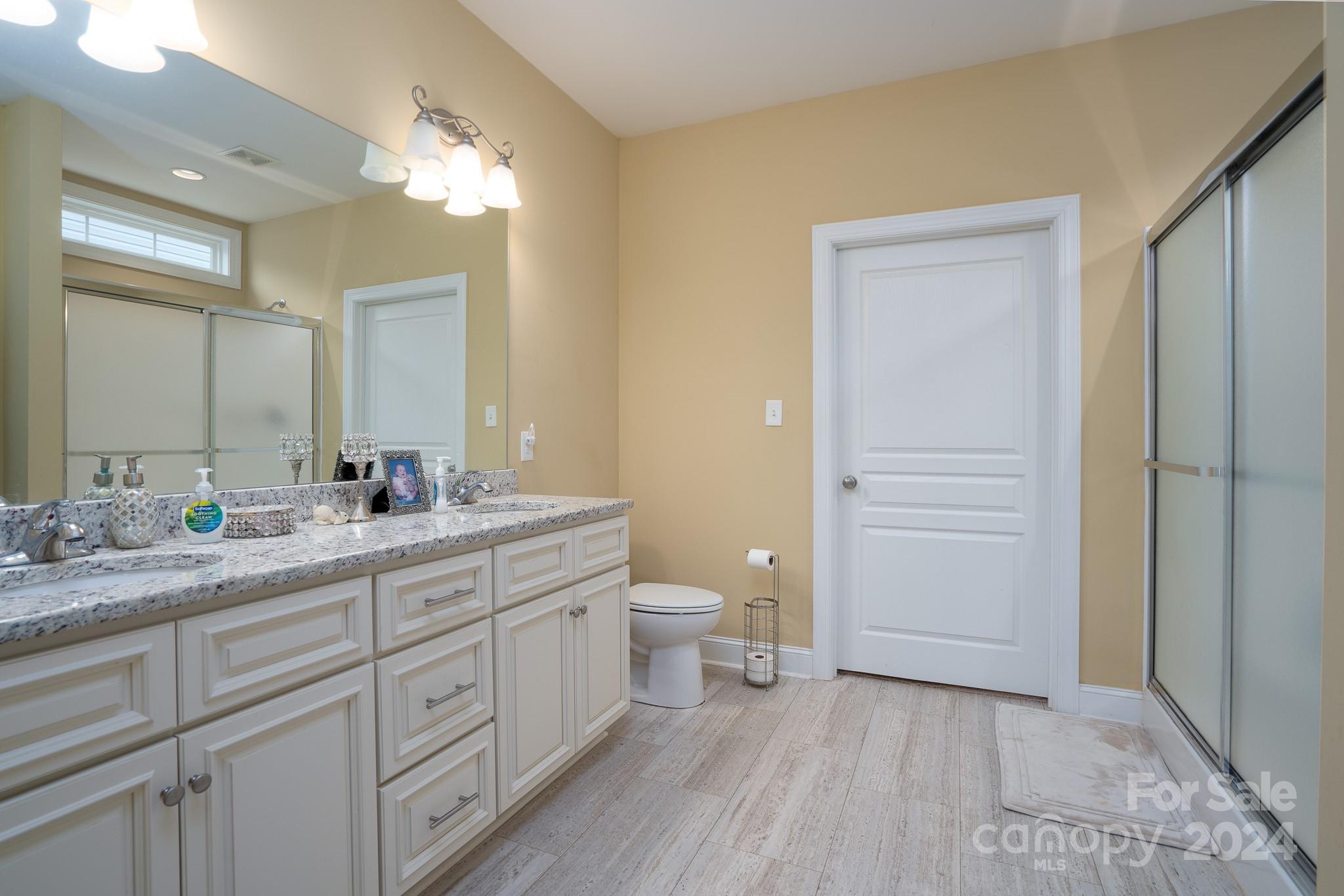 483 Pepperstone Drive Salisbury, NC 28146 - Photo 27 of 35 a spacious bathroom with a double vanity sink a toilet and a mirror