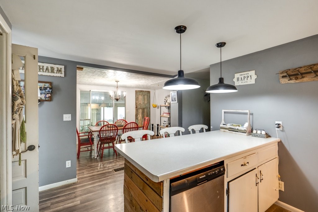 4219 Lake Rockwell Road Ravenna, OH 44266 - Photo 6 of 32 Kitchen with a notable chandelier, decorative light fixtures, dishwasher, and wood-type flooring