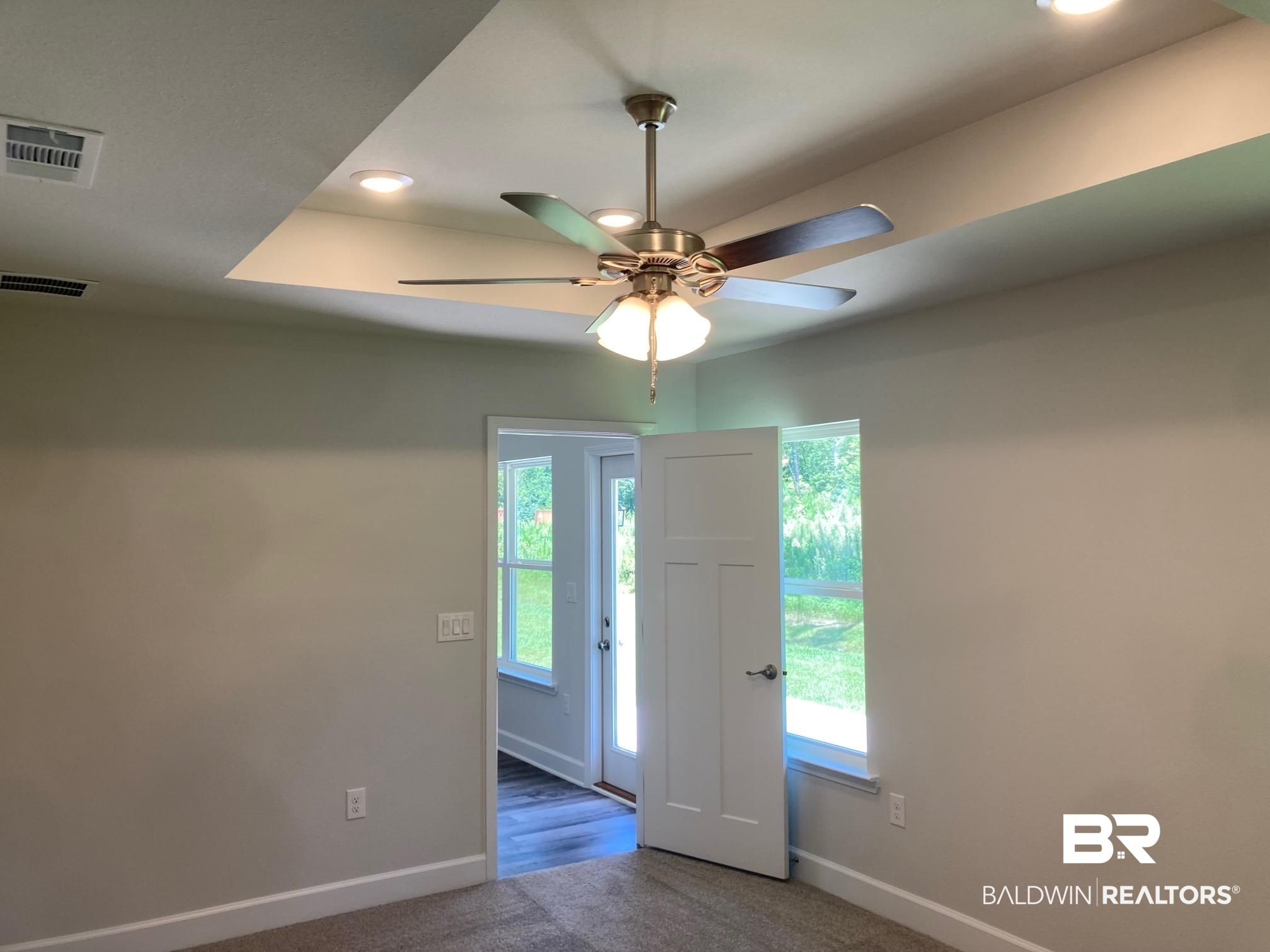 696 Mayflower Drive Foley, AL 36535 - Photo 17 of 25 Spare room featuring a ceiling fan, carpet floors, recessed lighting, and a raised ceiling