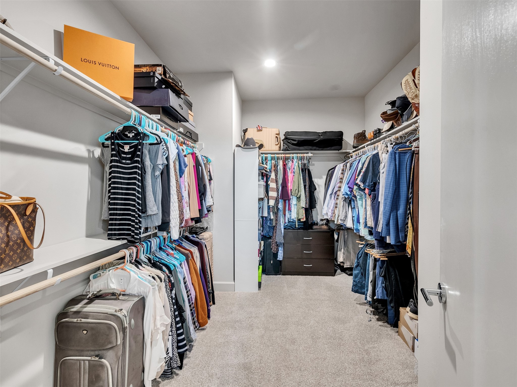 5702 Rucio Lane Houston, TX 77092 - Photo 17 of 30 a view of walk in closet with clothes and shoes