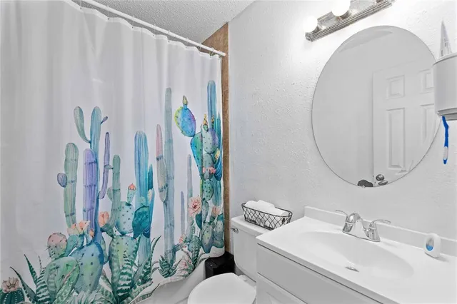 a bathroom with a sink a mirror and a toilet