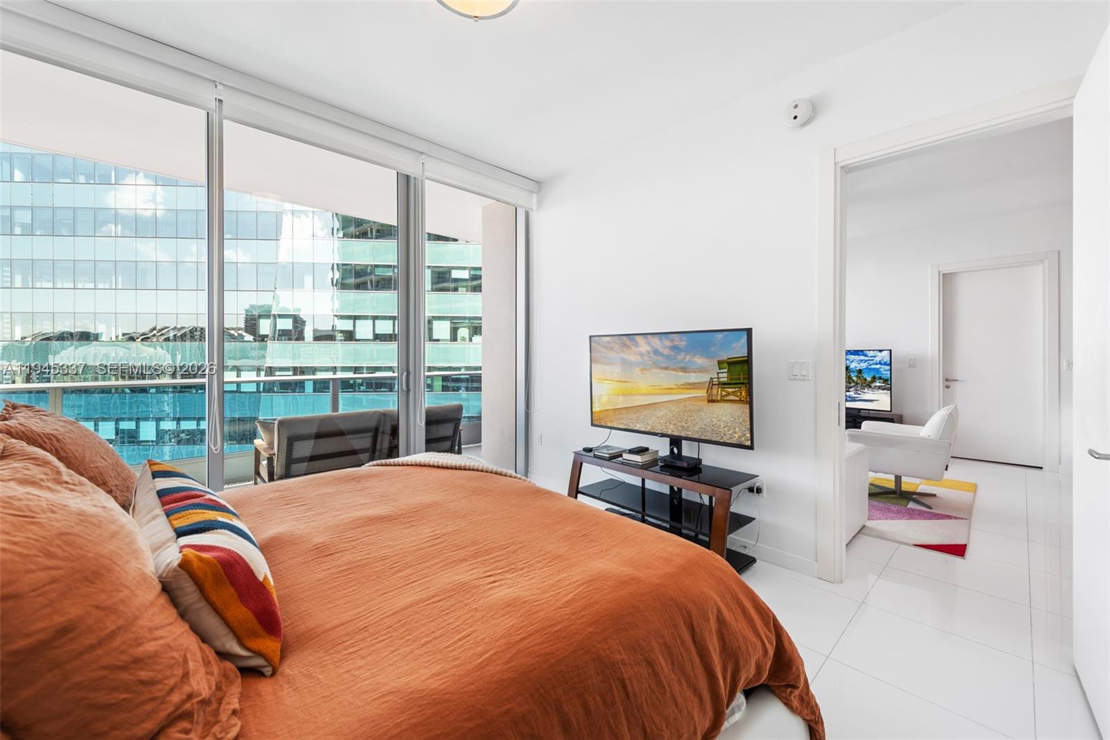 200 Biscayne Blvd Way, Unit 4511 Miami, FL 33131 - Photo 12 of 20 a bedroom with a bed and glass windows