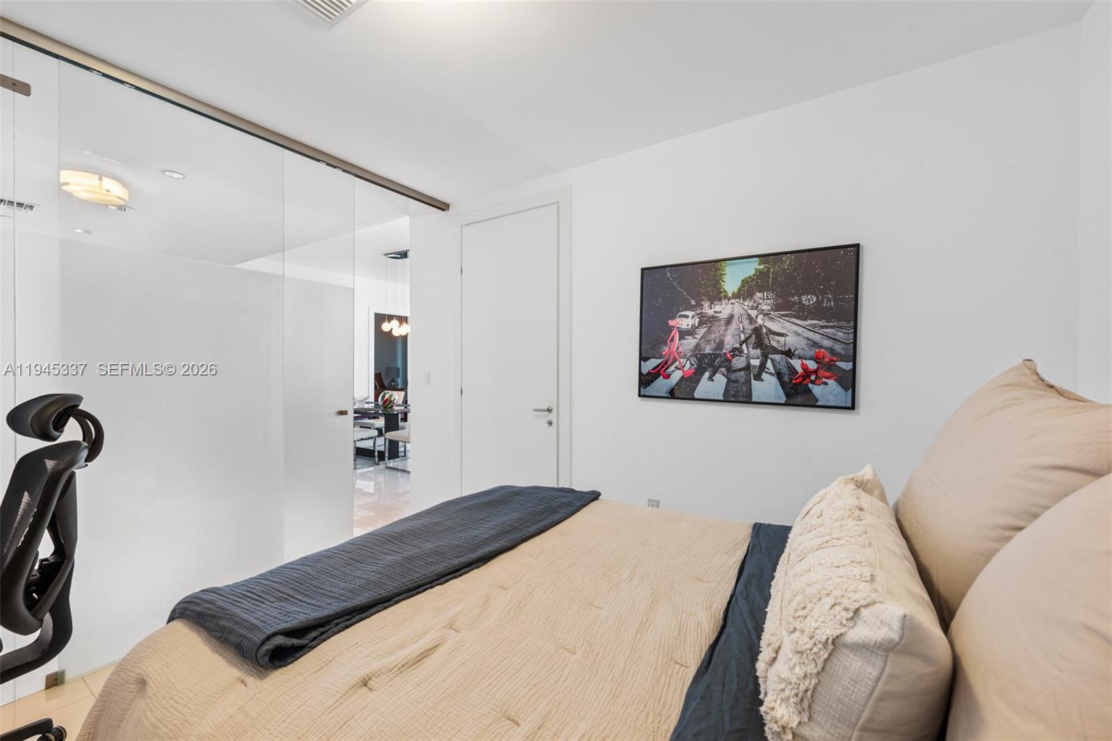 200 Biscayne Blvd Way, Unit 4511 Miami, FL 33131 - Photo 14 of 20 a bedroom with a bed and a painting on the wall