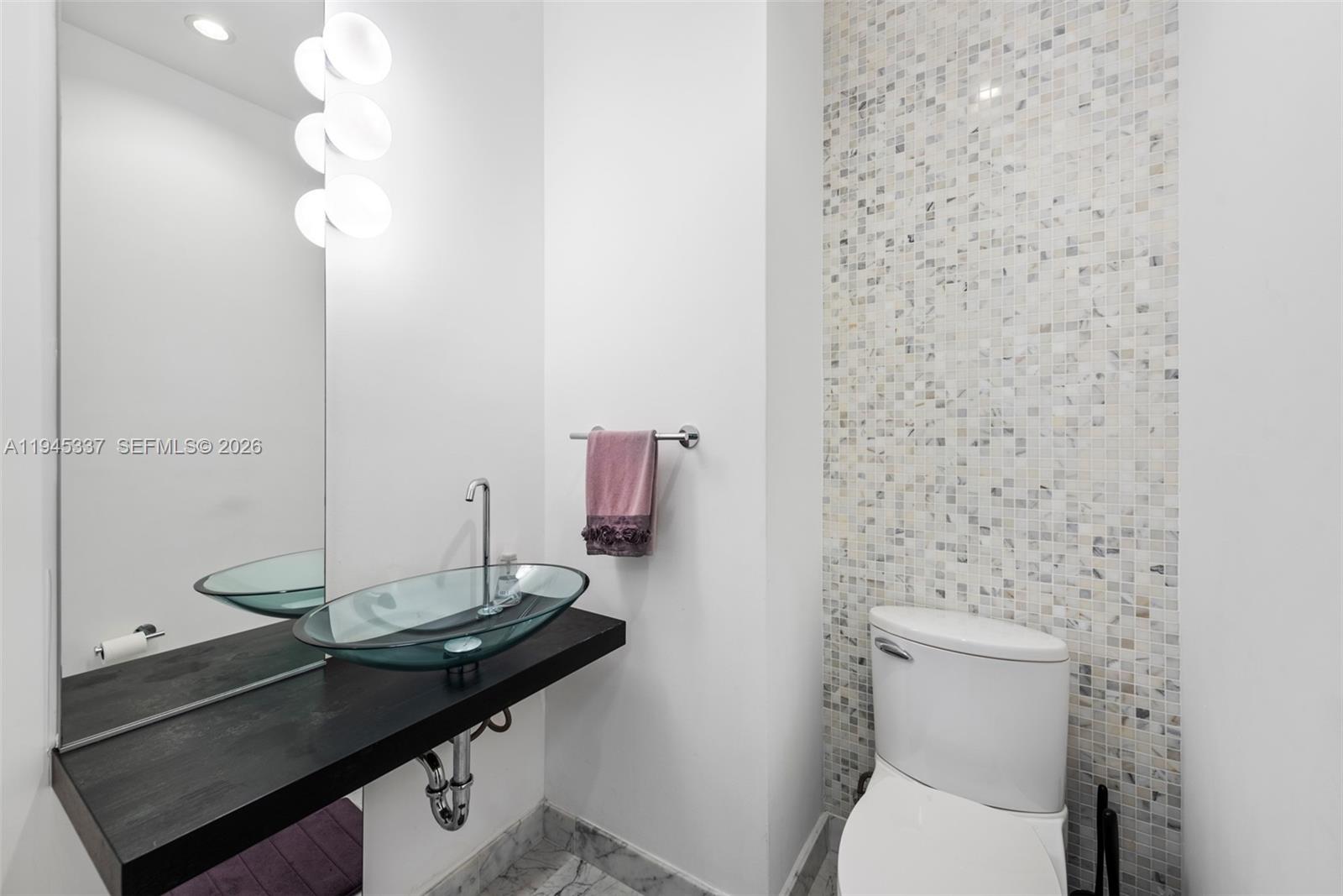 200 Biscayne Blvd Way, Unit 4511 Miami, FL 33131 - Photo 16 of 20 a bathroom with a sink a toilet and mirror