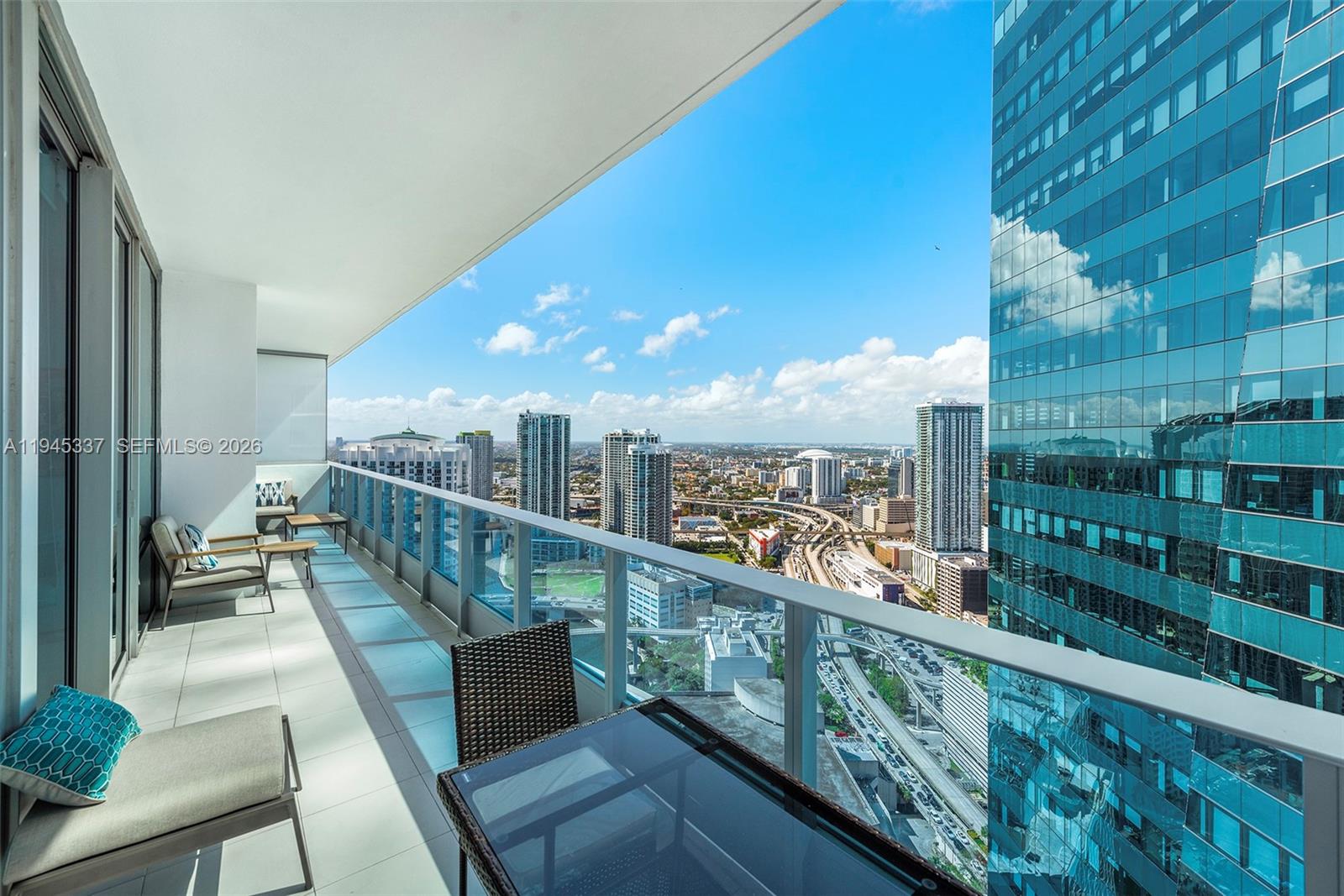 200 Biscayne Blvd Way, Unit 4511 Miami, FL 33131 - Photo 17 of 20 a view of a balcony with wooden benches