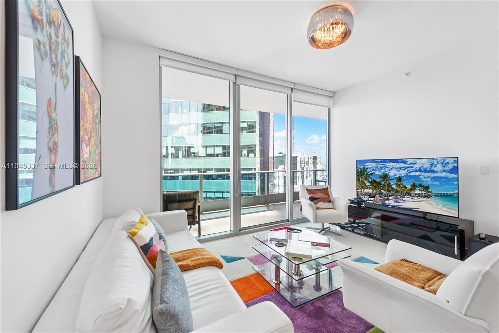 200 Biscayne Blvd Way, Unit 4511 Miami, FL 33131 - Photo 2 of 20 a living room with furniture and a flat screen tv