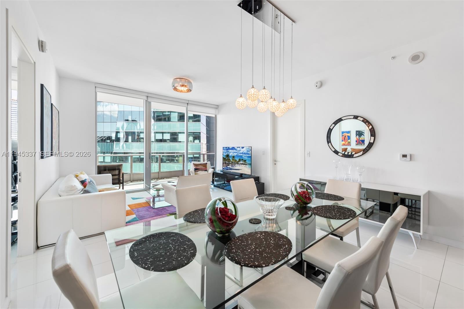 200 Biscayne Blvd Way, Unit 4511 Miami, FL 33131 - Photo 4 of 20 a living room with furniture a chandelier and a table