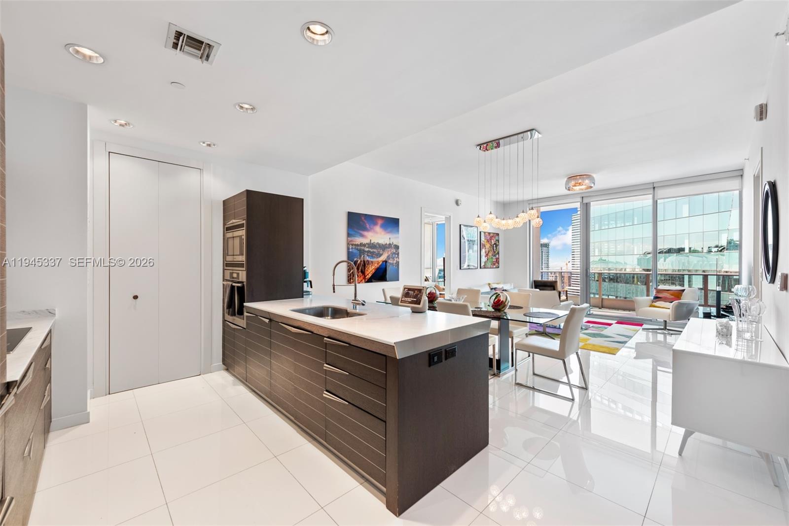 200 Biscayne Blvd Way, Unit 4511 Miami, FL 33131 - Photo 6 of 20 a view of a kitchen counter top space with stainless steel appliances wooden floor and windows