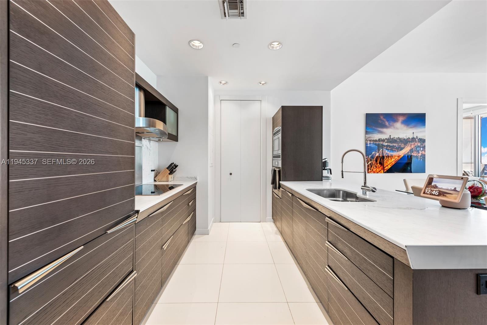 200 Biscayne Blvd Way, Unit 4511 Miami, FL 33131 - Photo 8 of 20 a kitchen with stainless steel appliances a sink stove and cabinets