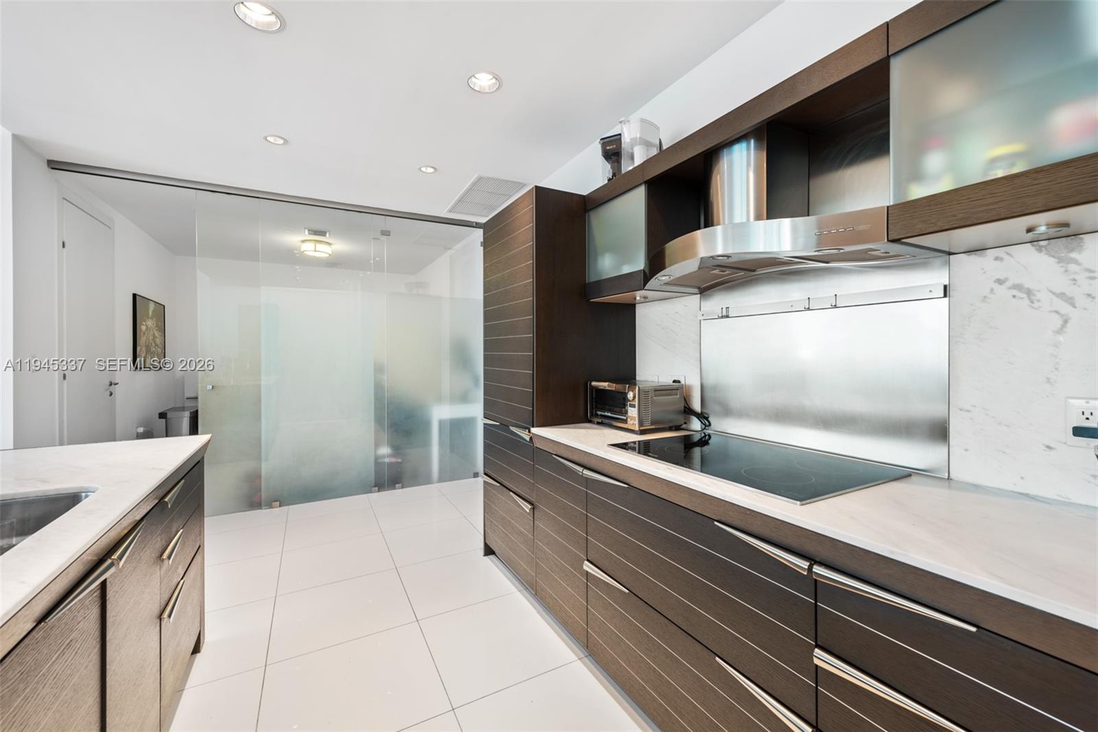 200 Biscayne Blvd Way, Unit 4511 Miami, FL 33131 - Photo 9 of 20 a kitchen with a sink and cabinets
