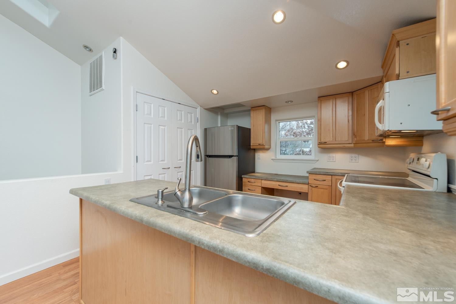 1290 Gordon Avenue Reno, NV 89509 - Photo 29 of 40 a kitchen with stainless steel appliances granite countertop a sink and a refrigerator