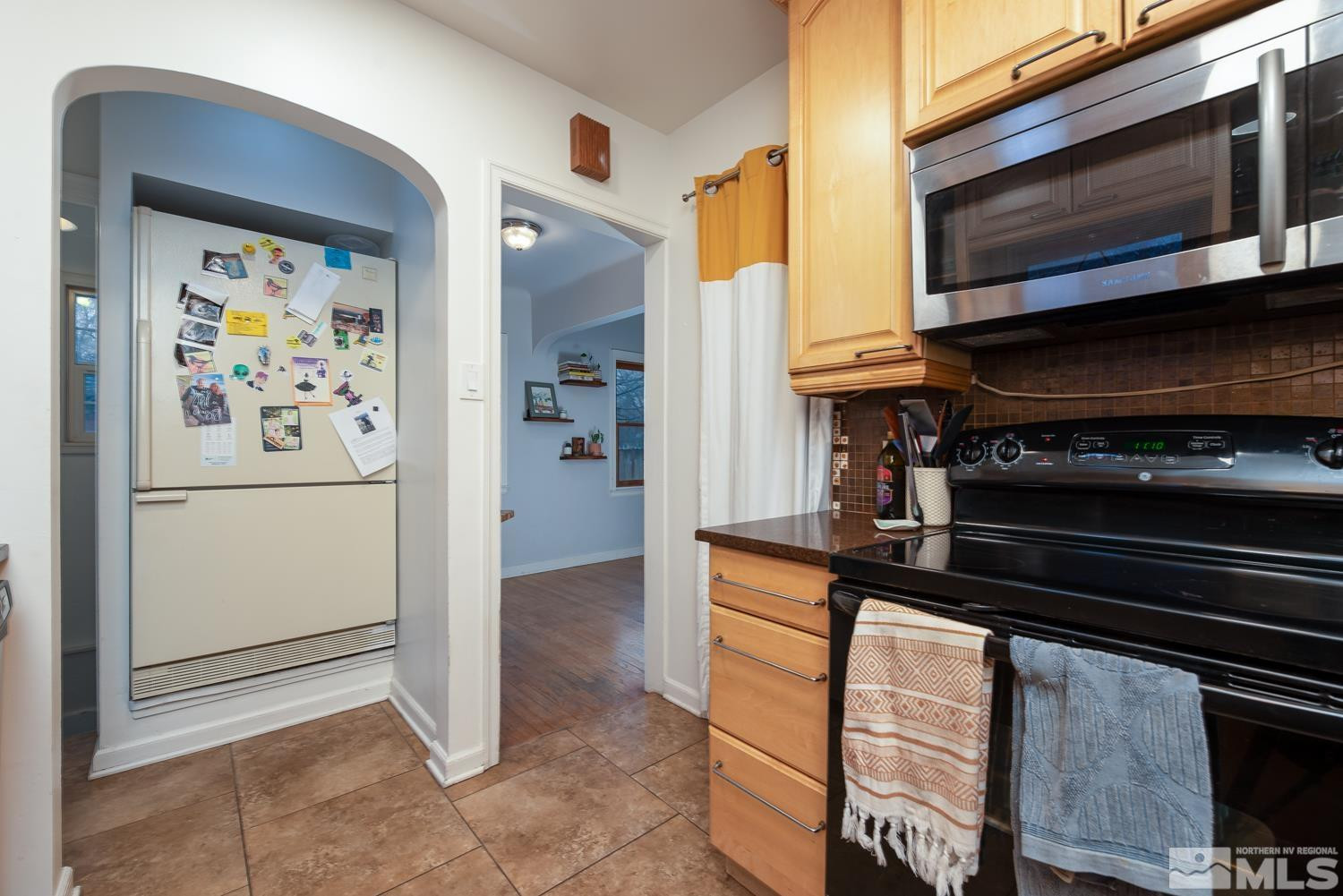 1290 Gordon Avenue Reno, NV 89509 - Photo 8 of 40 a kitchen with stainless steel appliances a refrigerator and a stove top oven