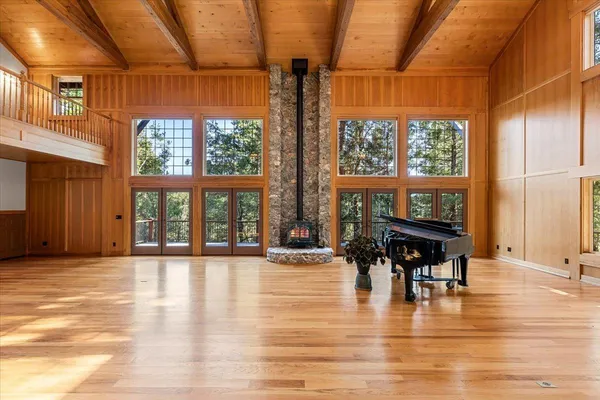 en empty room with window and wooden floor