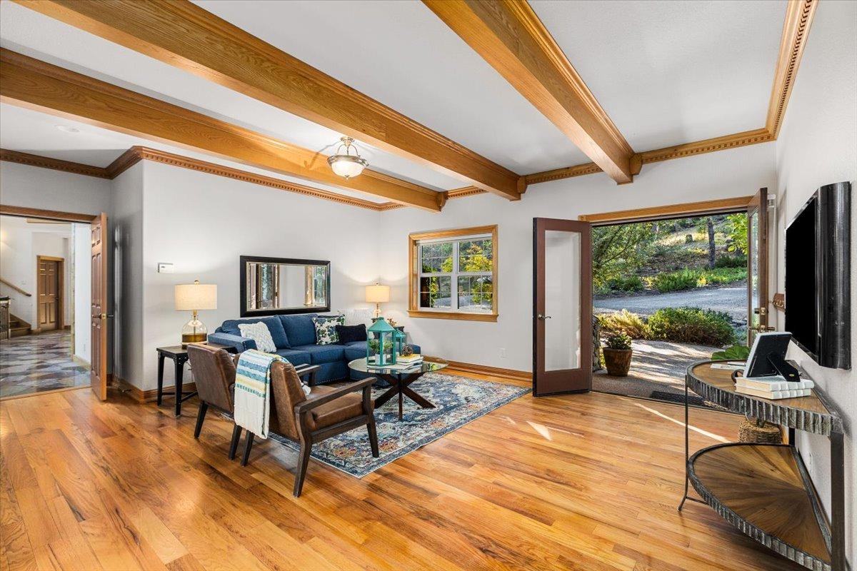 21293 Scotts Flat Road Nevada City, CA 95959 - Photo 16 of 62 a living room with furniture a flat screen tv and a floor to ceiling window