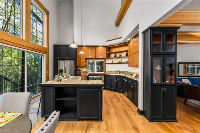 a kitchen with stainless steel appliances granite countertop sink stove and cabinets