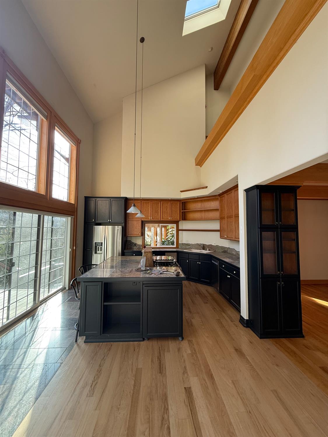 21293 Scotts Flat Road Nevada City, CA 95959 - Photo 19 of 62 a living room with stainless steel appliances furniture a large window and a wooden floor