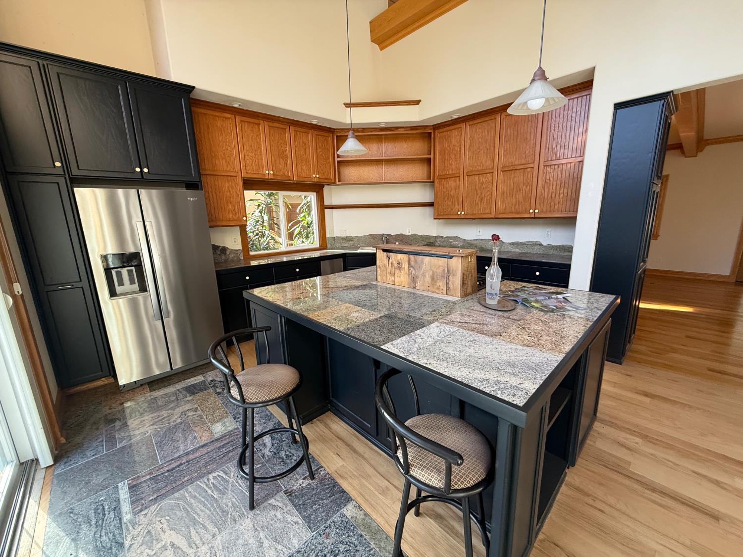 21293 Scotts Flat Road Nevada City, CA 95959 - Photo 22 of 62 a kitchen with stainless steel appliances granite countertop a kitchen island a stove a sink a refrigerator dining table and chairs with wooden floor