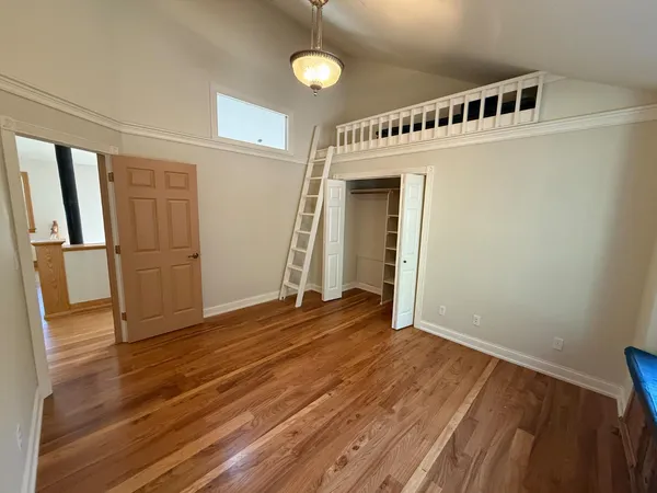 a living room with furniture and wooden floors