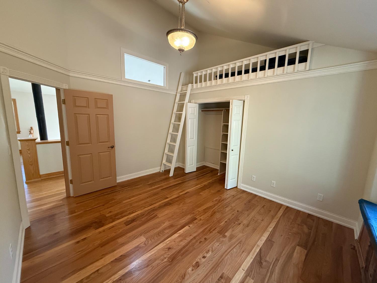 21293 Scotts Flat Road Nevada City, CA 95959 - Photo 37 of 62 an empty room with wooden floor and windows