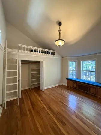 a bed room with a bed and a chair