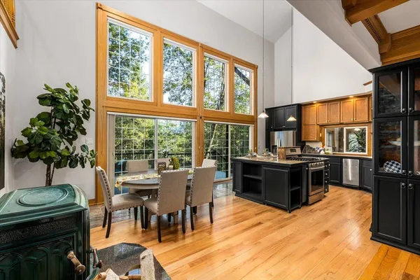 a balcony with wooden floor table and chairs