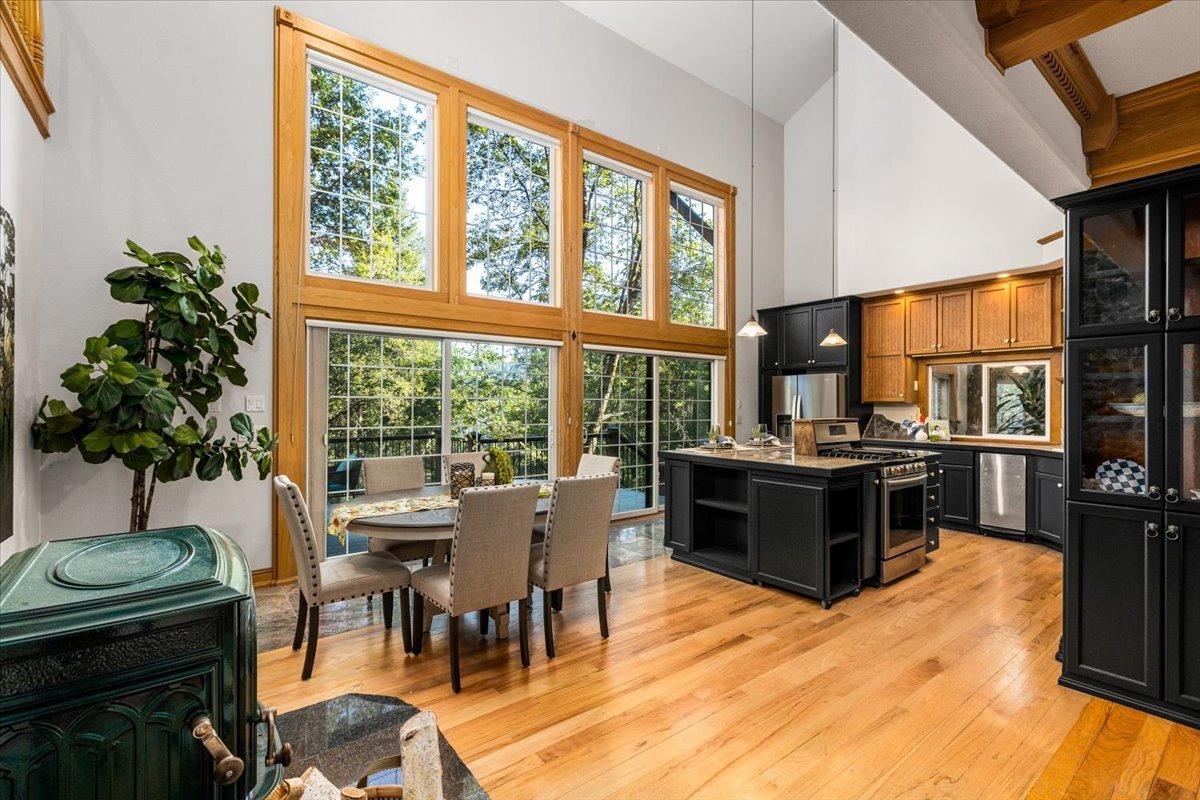 21293 Scotts Flat Road Nevada City, CA 95959 - Photo 5 of 62 a living room with furniture a flat screen tv and a floor to ceiling window