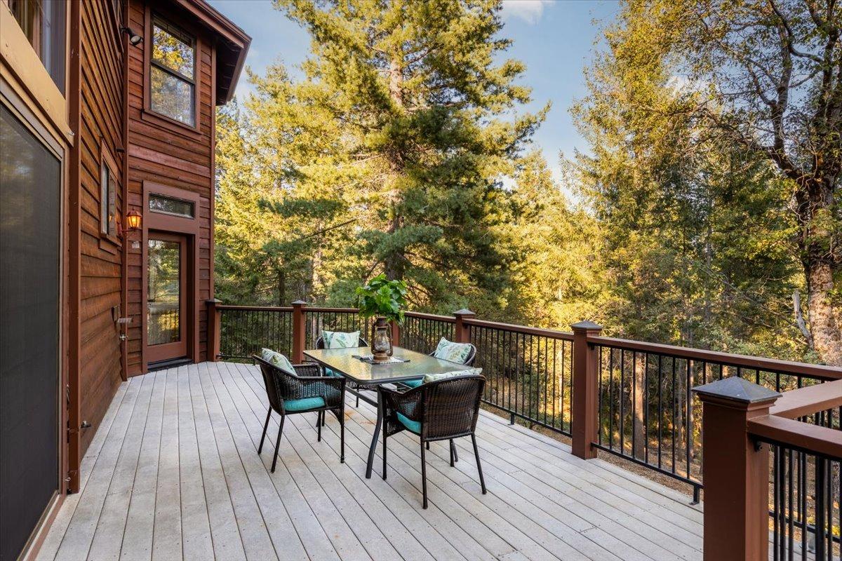 21293 Scotts Flat Road Nevada City, CA 95959 - Photo 6 of 62 a balcony with wooden floor table and chairs