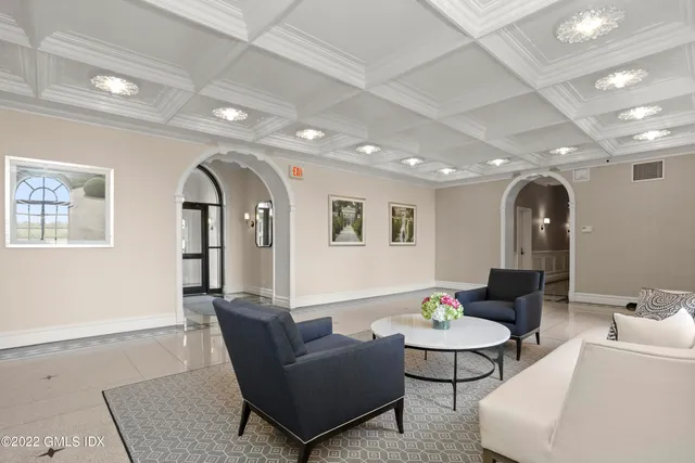 a lobby with furniture and floor to ceiling window