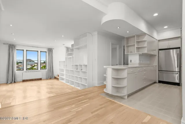 a kitchen with white cabinets and stainless steel appliances