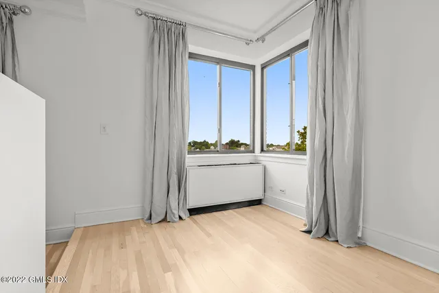 a bedroom with a large window and a bed