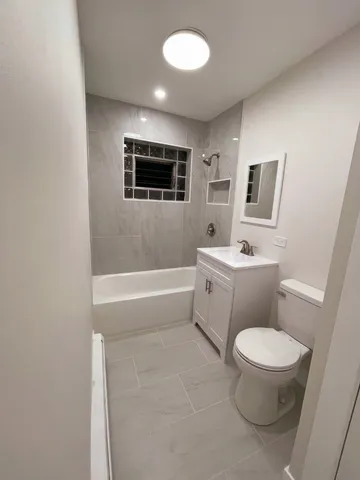 a bathroom with a toilet a sink and bathtub
