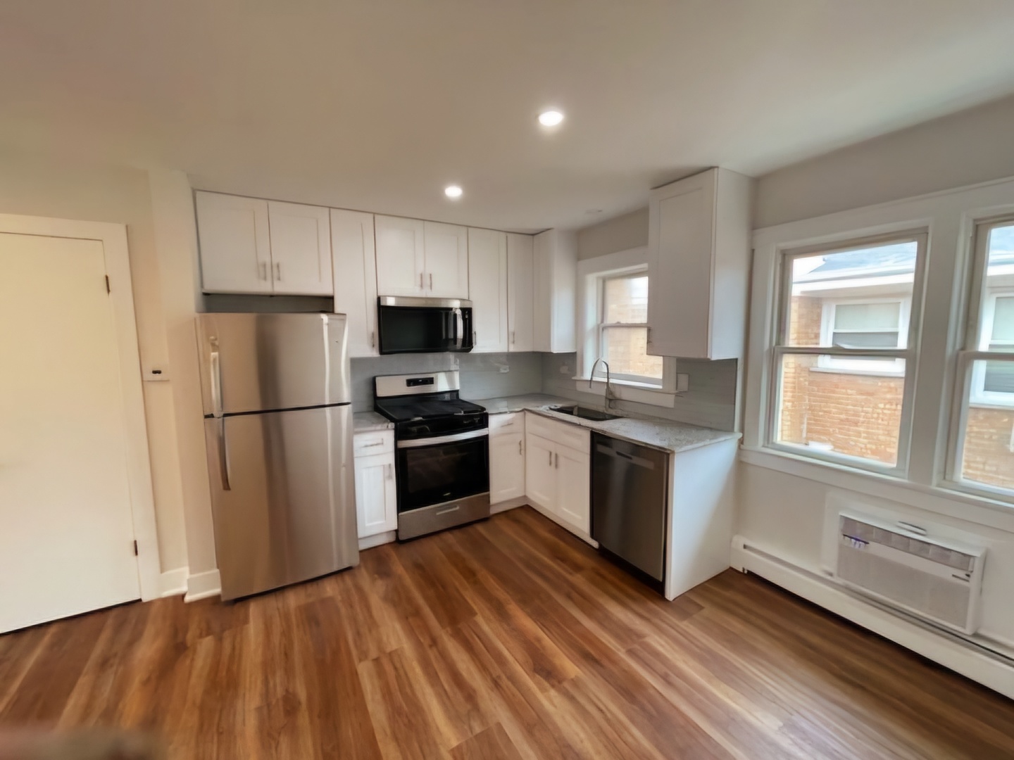 8228 West Walsh Lane, Unit 3F River Grove, IL 60171 - Photo 18 of 20 a kitchen with granite countertop stainless steel appliances a refrigerator sink and microwave