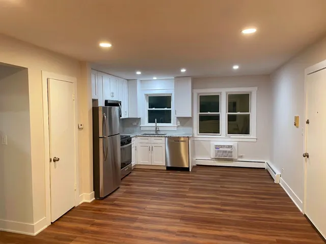 a view of kitchen with refrigerator microwave and cabinets