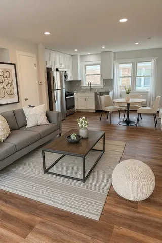 a living room with furniture and kitchen view