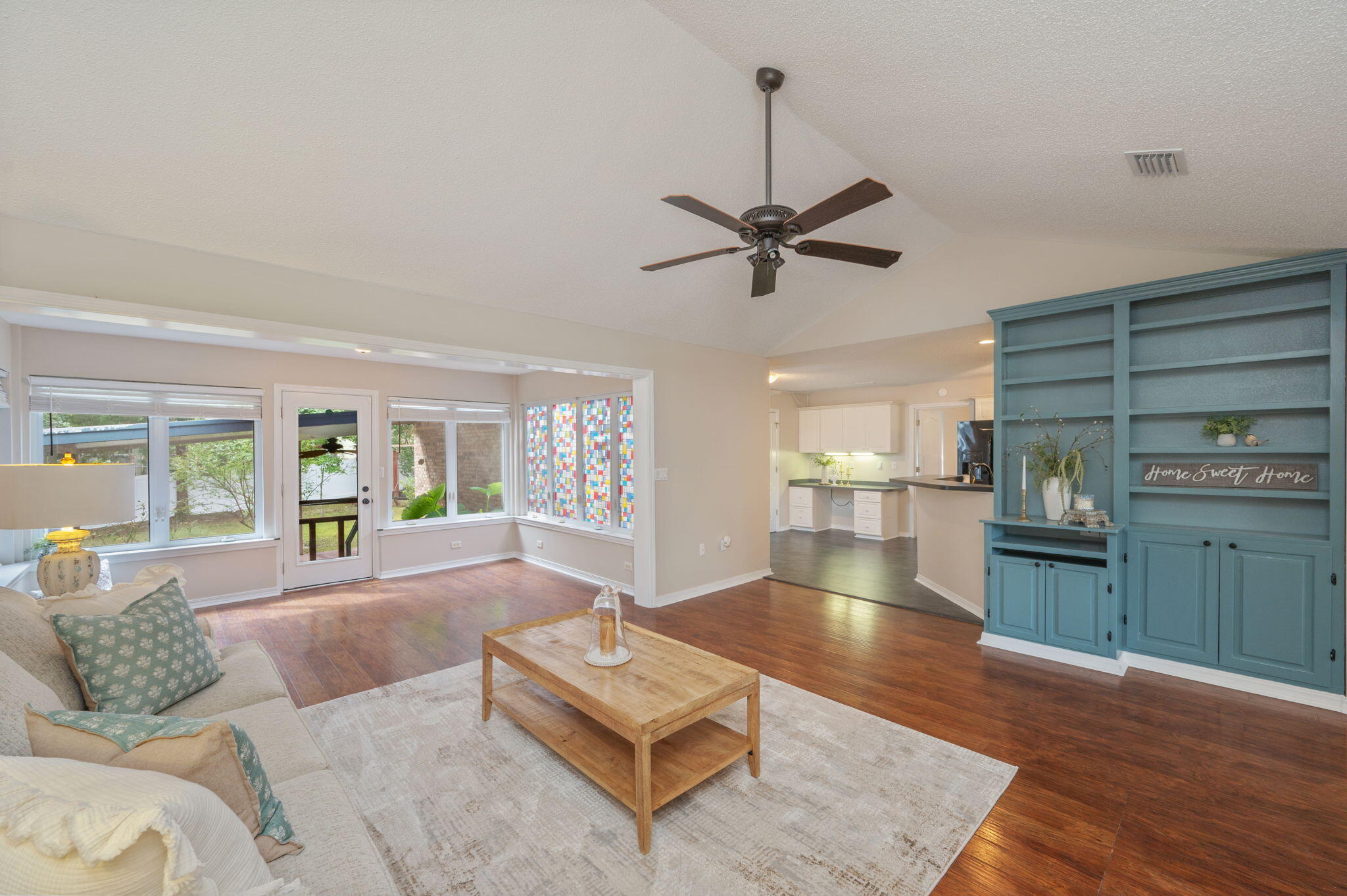 109 Eagle Drive Crestview, FL 32536 - Photo 11 of 52 a large living room with stainless steel appliances granite countertop a couch wooden floor and a fireplace